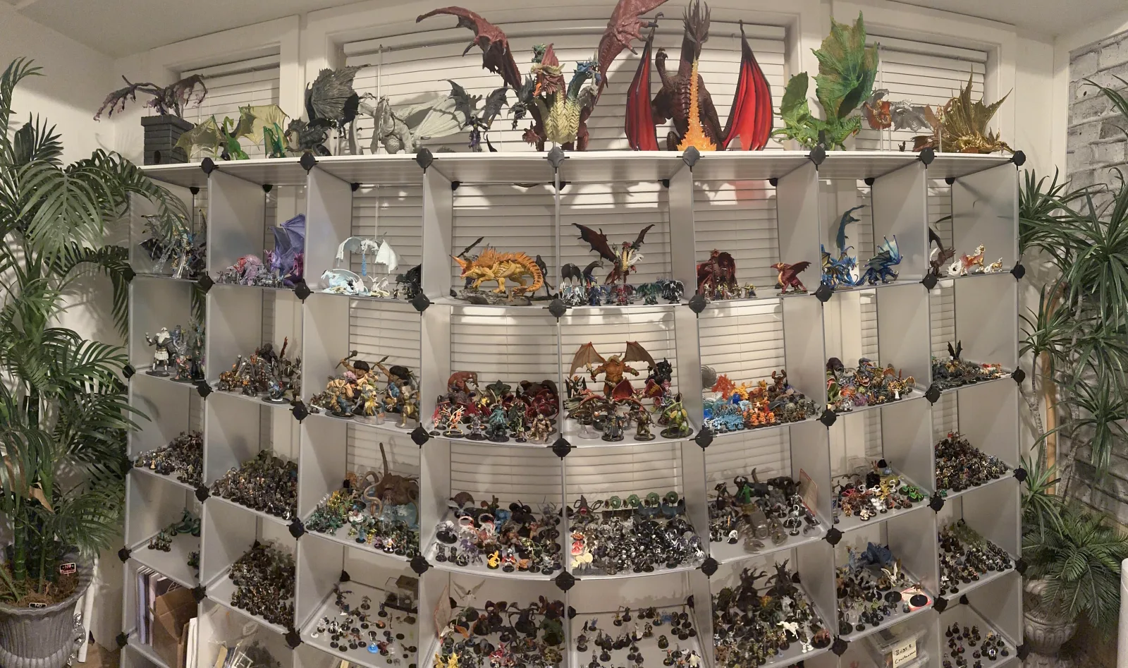 Shelves of miniatures in the Den's library